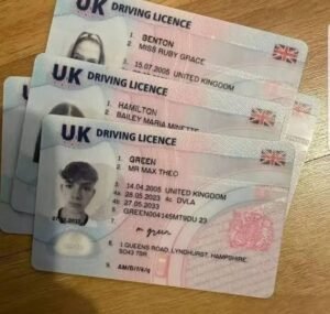 Stack of UK driving licence cards displayed on a wooden table